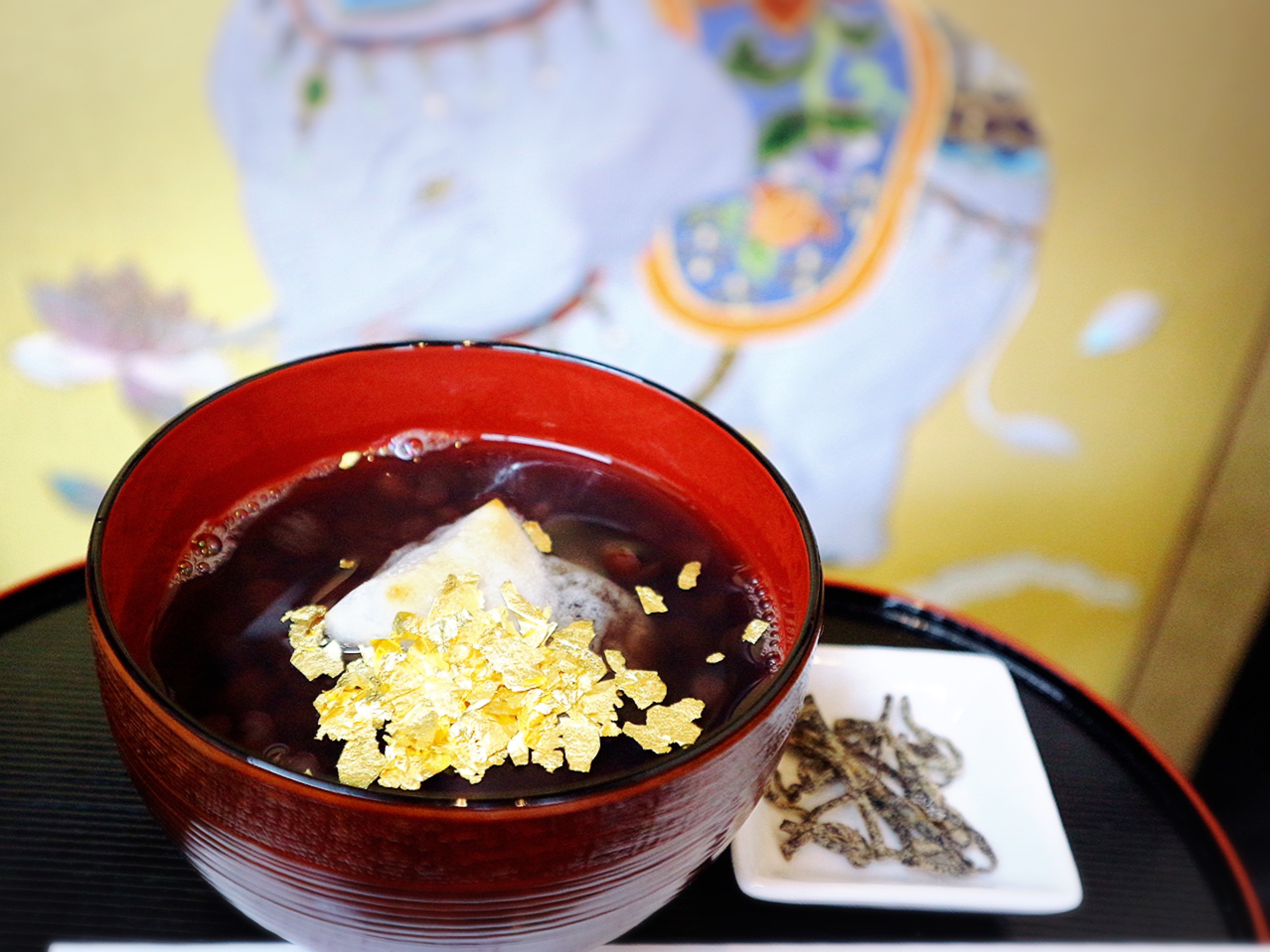 Red Azuki bean soup with small Rokujo rice cakes and golden leaves  